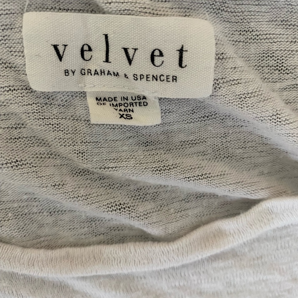 White tank top with ruffle sides.